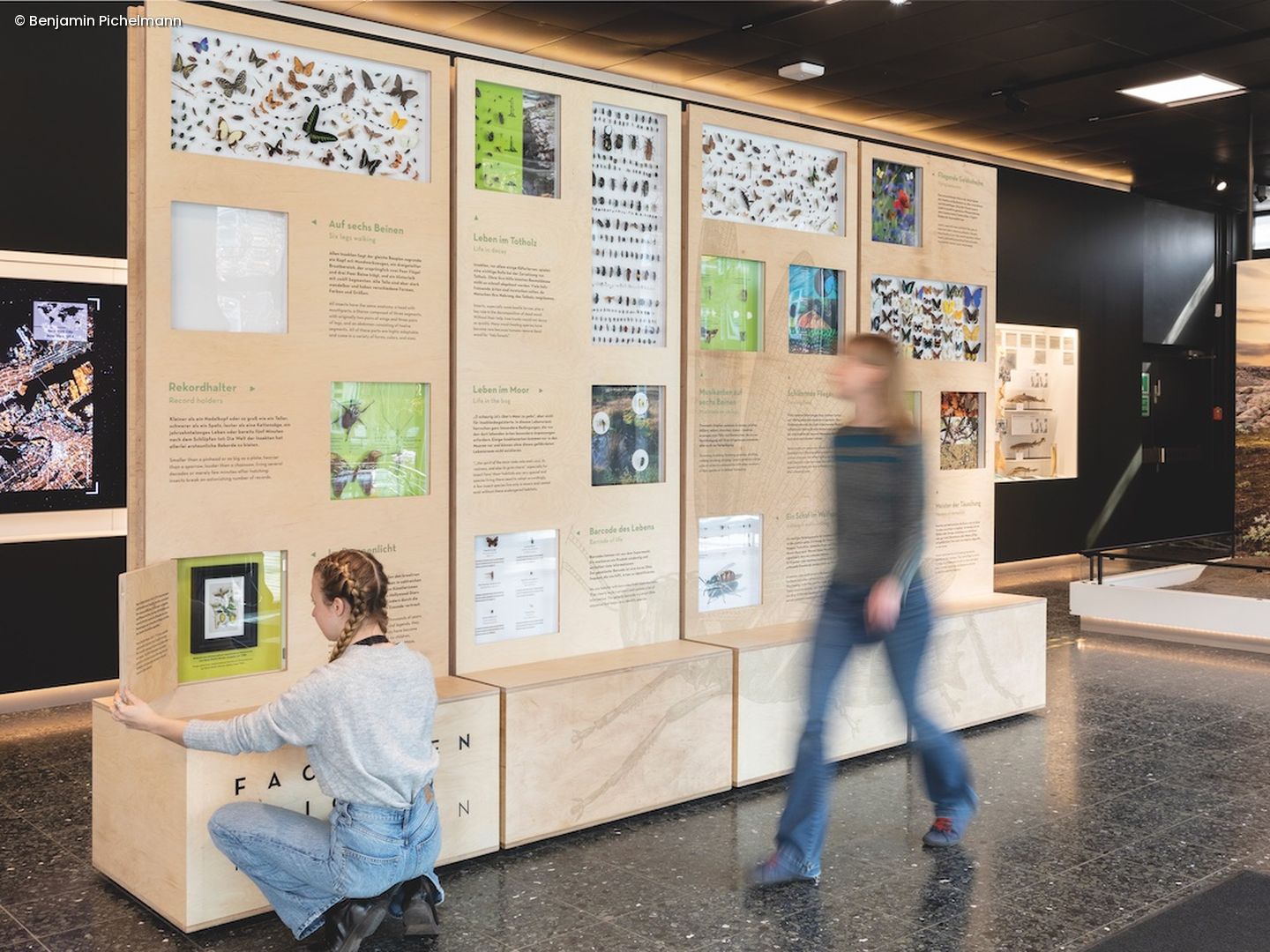 Ausstellung im Museum an der zwei Personen vorbeilaufen